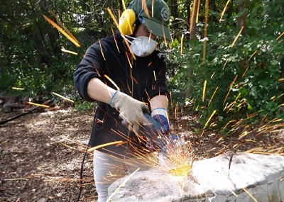 At Undercliff Picnic Area, Lisa Grosso works on the restoration of rustic picnic tables built in the 1930s by the Civilian Conservation Corps (CCC). | Photo: Anthony Taranto